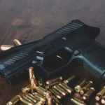 a gun and bullets on a table