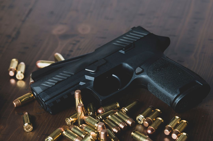 a gun and bullets on a table